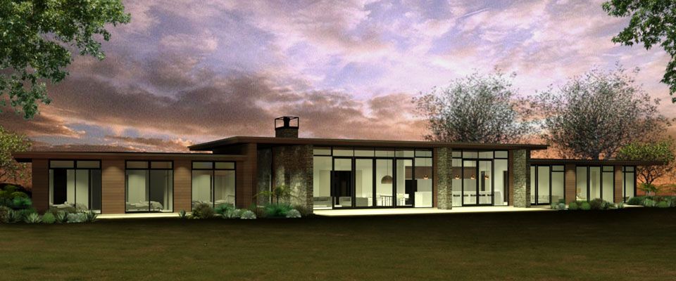 Low horizontal home with schist piers and timber cladding lit warmly at dusk