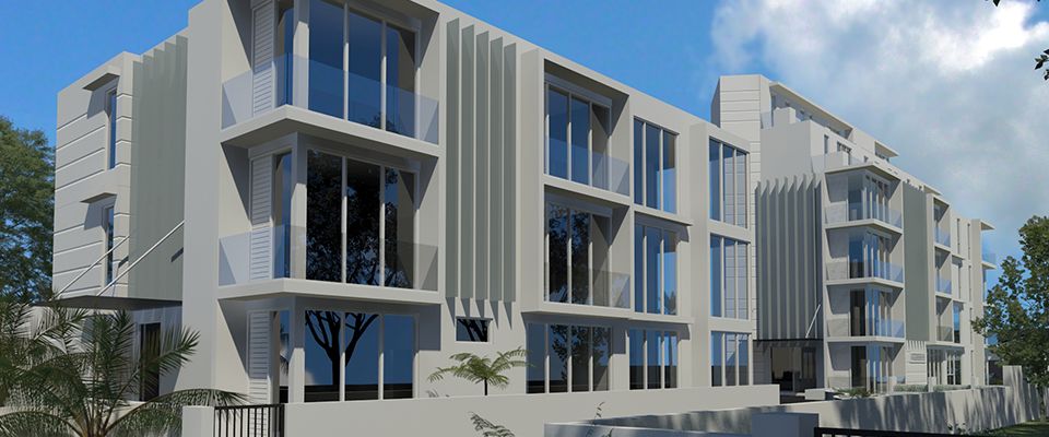 White apartment development with vertical fins and recessed balconies along a street